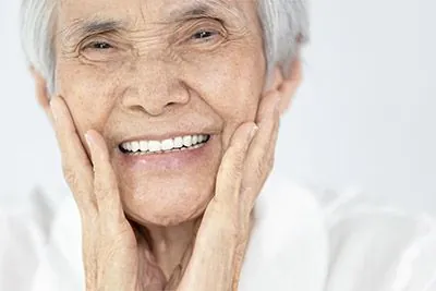 woman with dental implants from Gaither Perio and Dental Implants