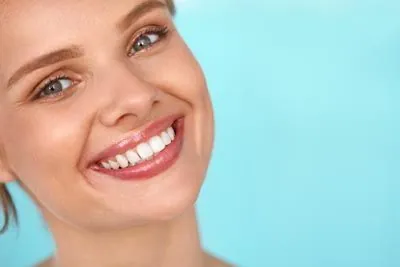 woman loving her smile after laser gum therapy