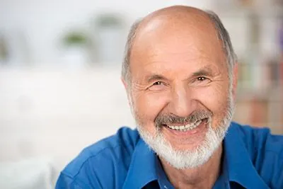man liking his smile after laser gum therapy